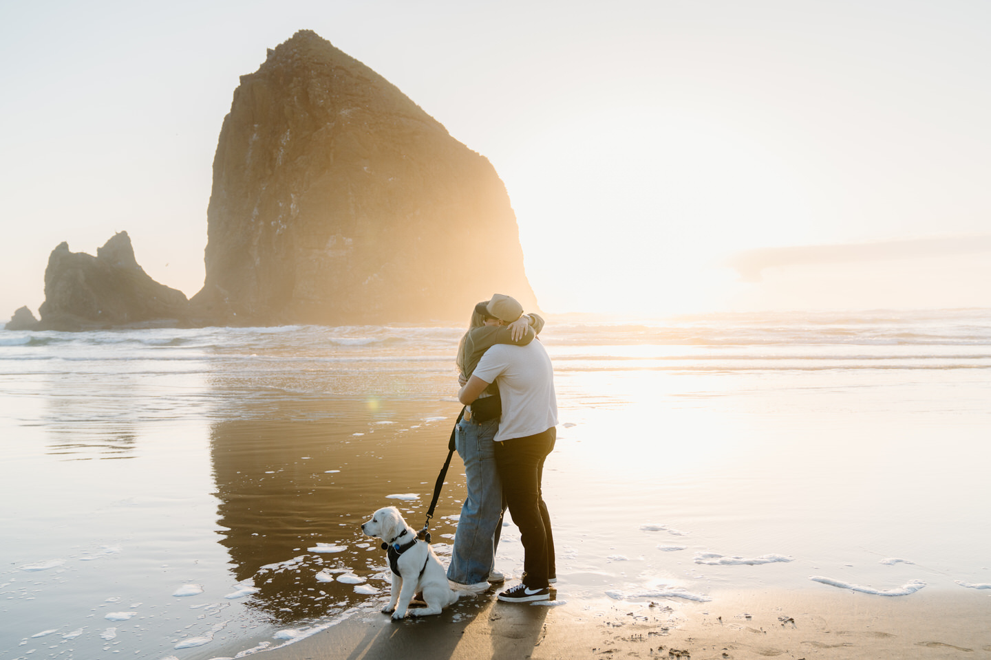 Couple hugs after getting engaged on the Oregon Coast