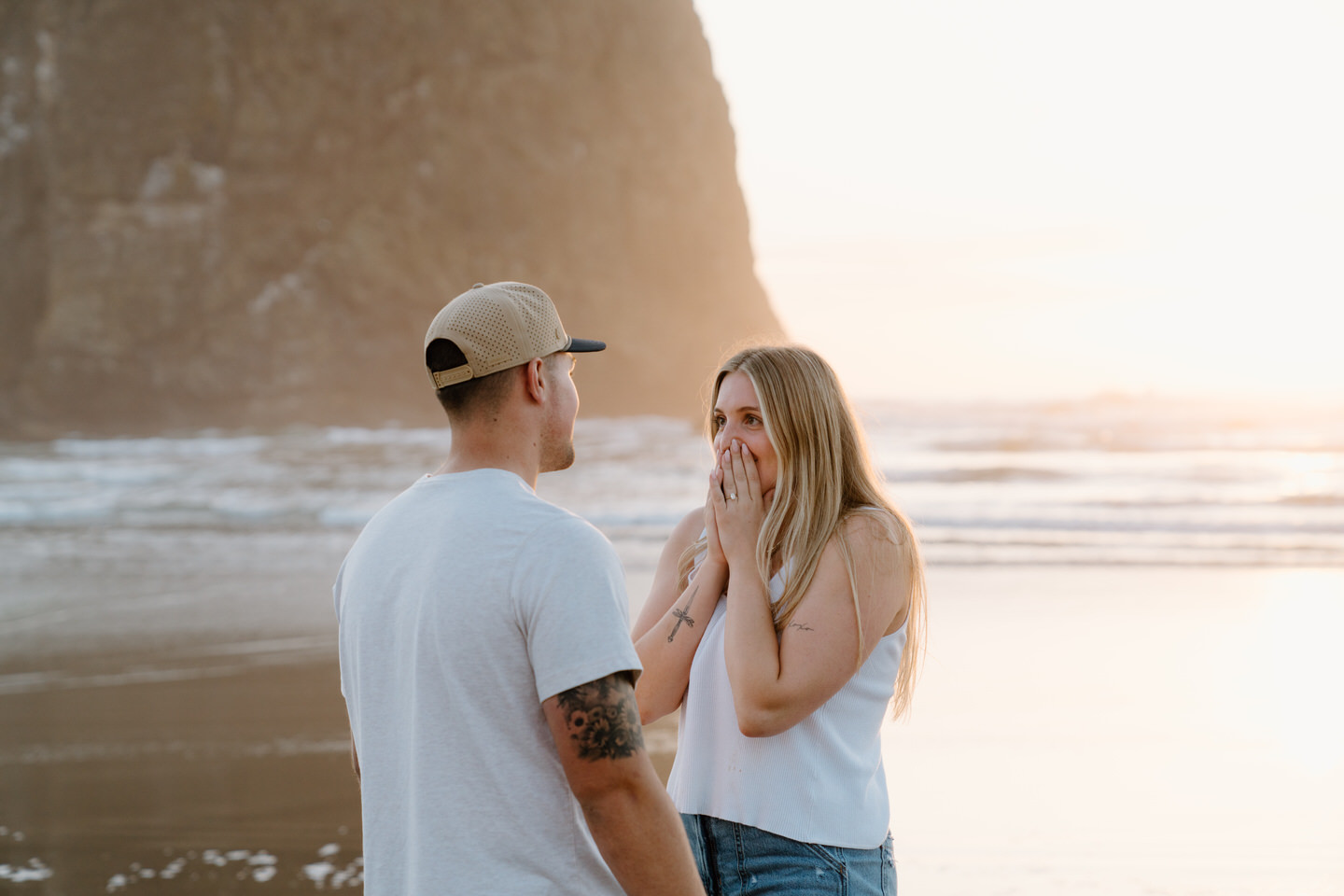 Woman surprised after getting engaged on Cannon Beach with an Oregon Coast photographer