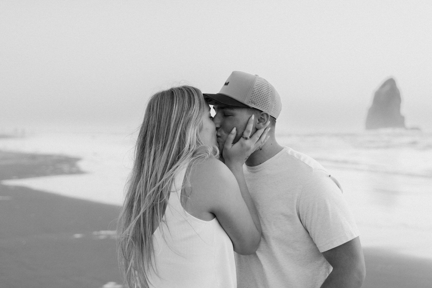 Couple kisses after engagement photos at the Oregon Coast