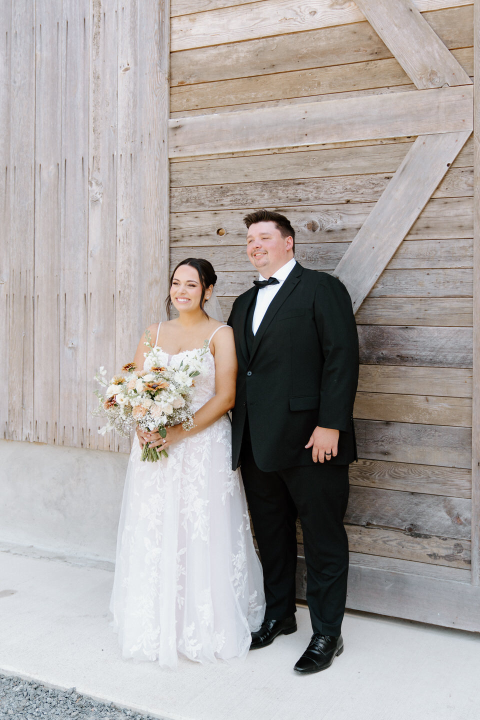 Bride and groom pose at their Springwater Lakes Estate wedding