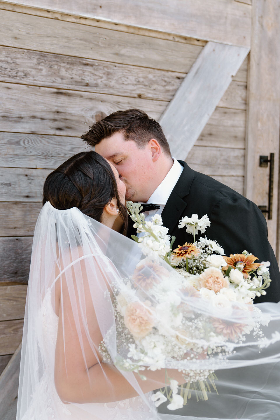 Veil and bridal bouquet at Springwater Lakes Estate wedding