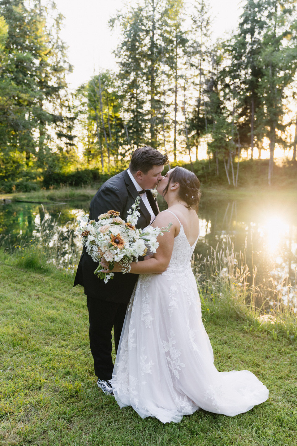 Couple kissing in front of lake