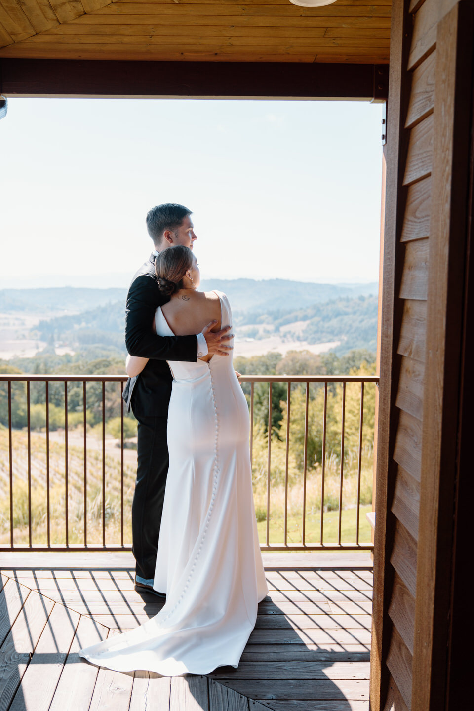 Bride and groom hug at winery wedding venue in Oregon