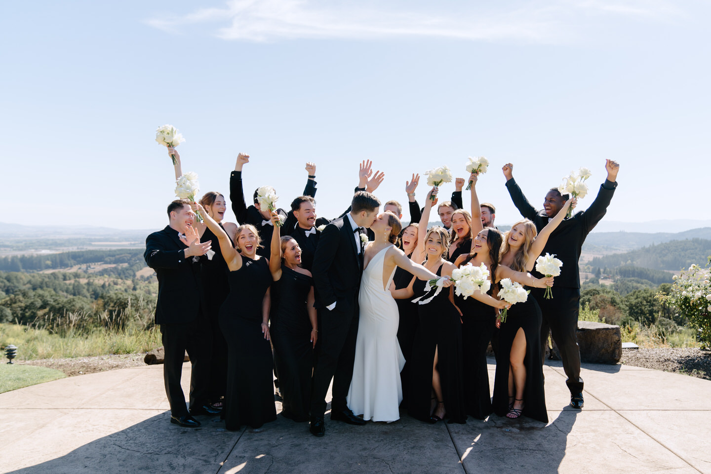 Wedding party cheers for bride and groom