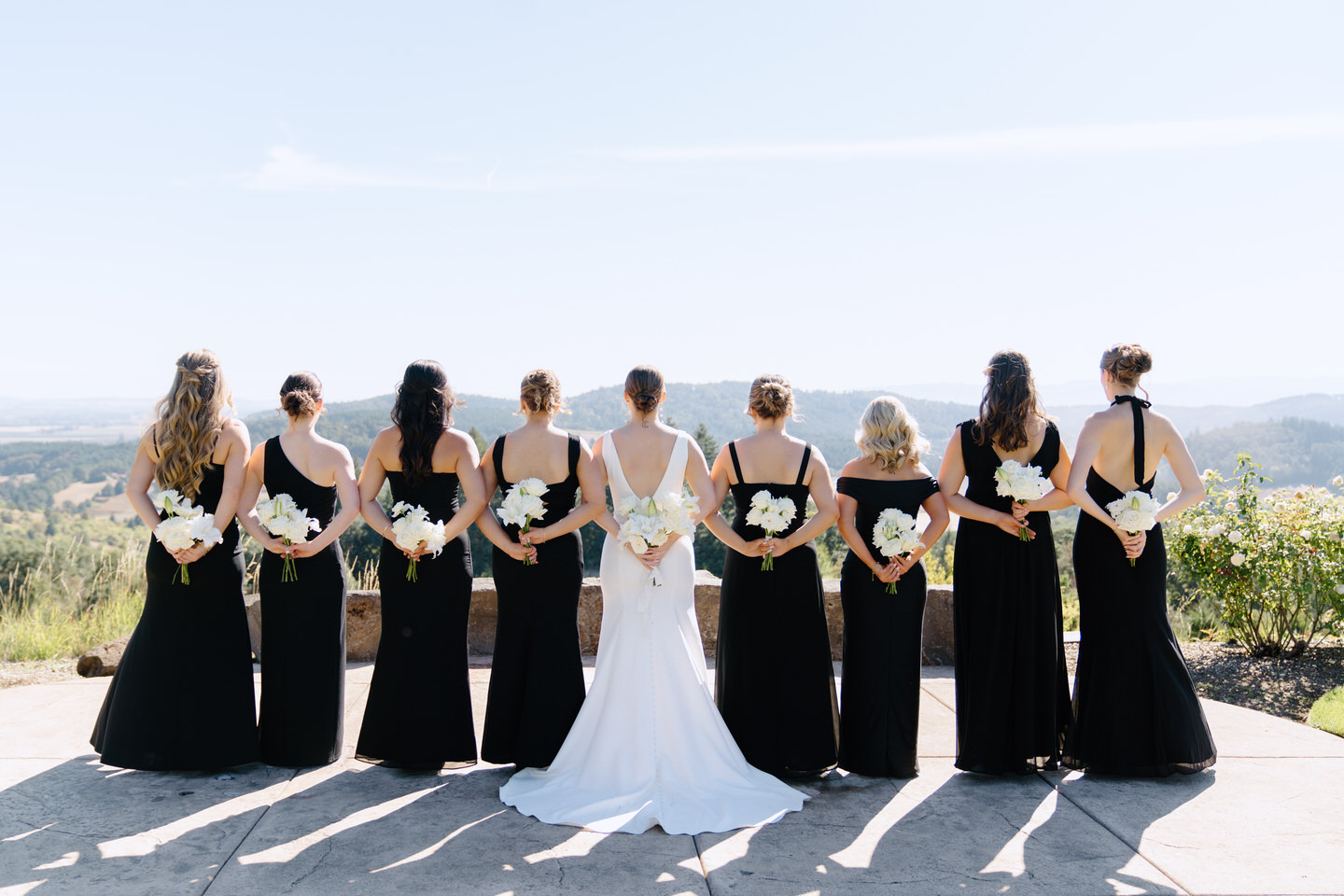 Bridesmaids with bouquets behind their backs