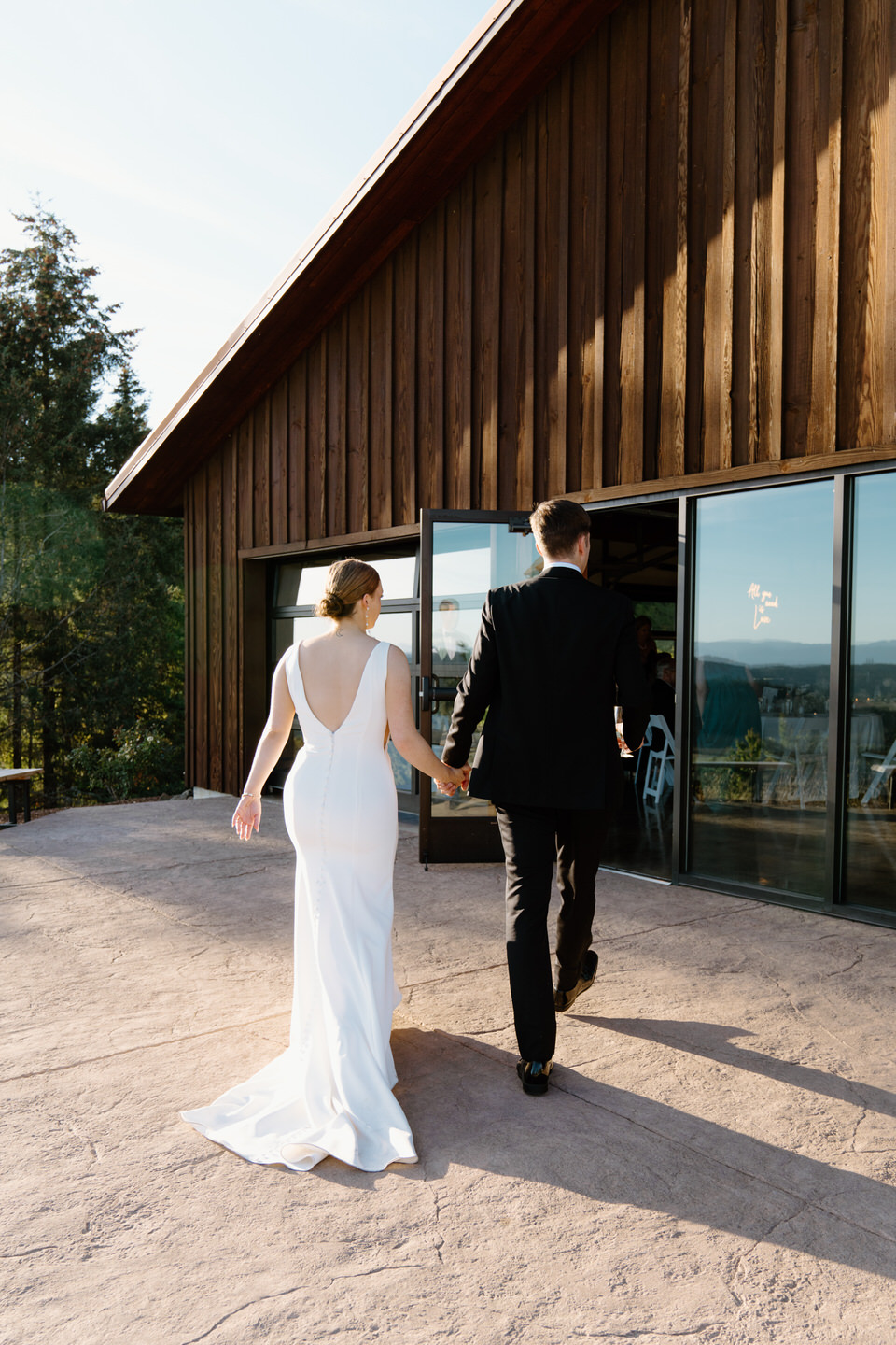 Bride and groom walking into their wedding reception