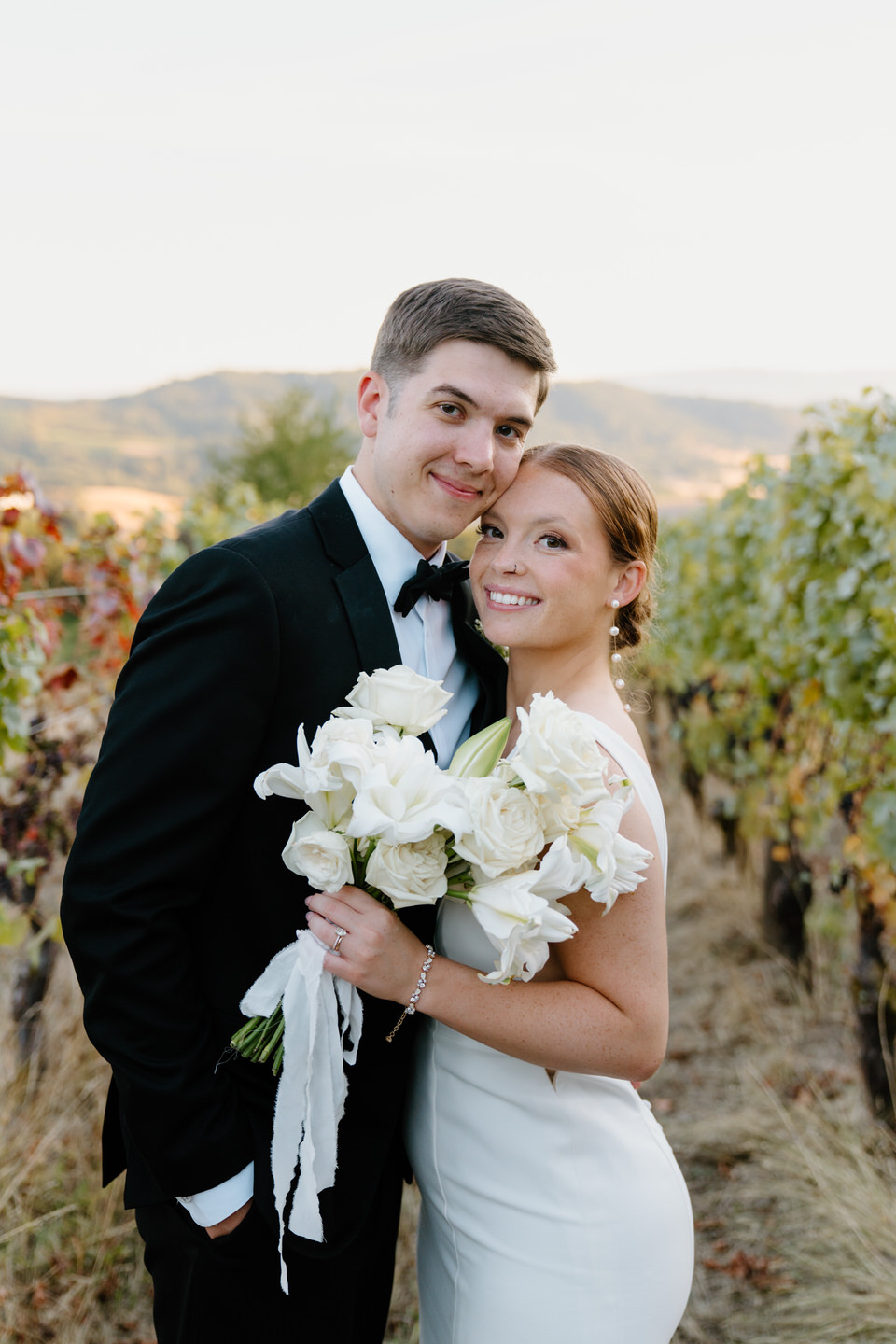 Bride and groom photos in the vineyard at their Oregon Wine Country wedding at Youngberg Hill.