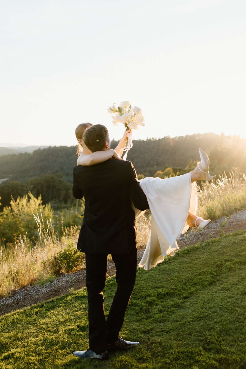 Groom spins bride around in his arms