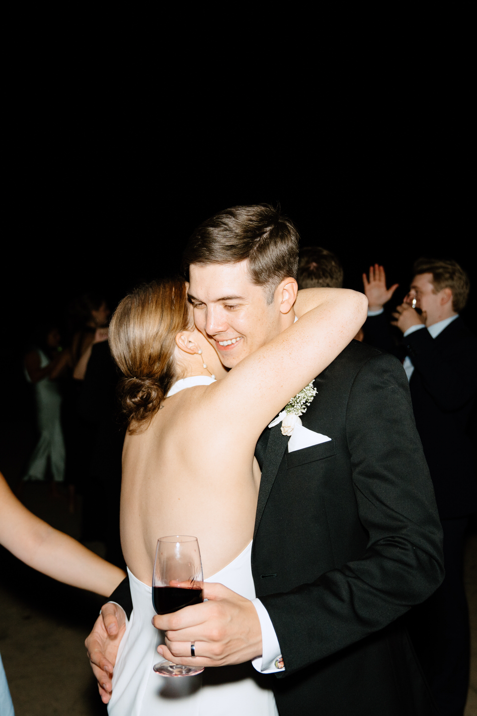 Bride and groom hug during wedding reception at Youngberg Hill