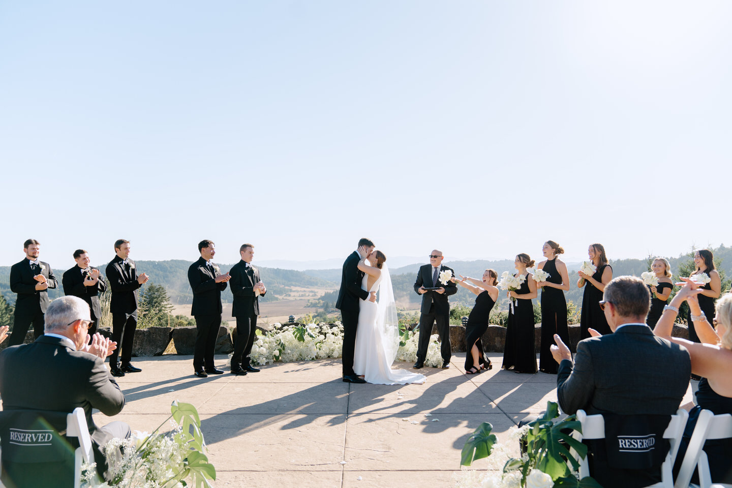 Bride and groom kiss during their wedding ceremony