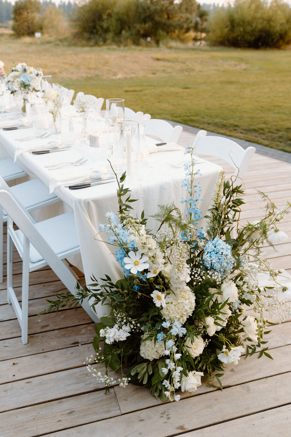 Elegant white table with minimal decor, set against Black Butte, Oregon's serene backdrop.