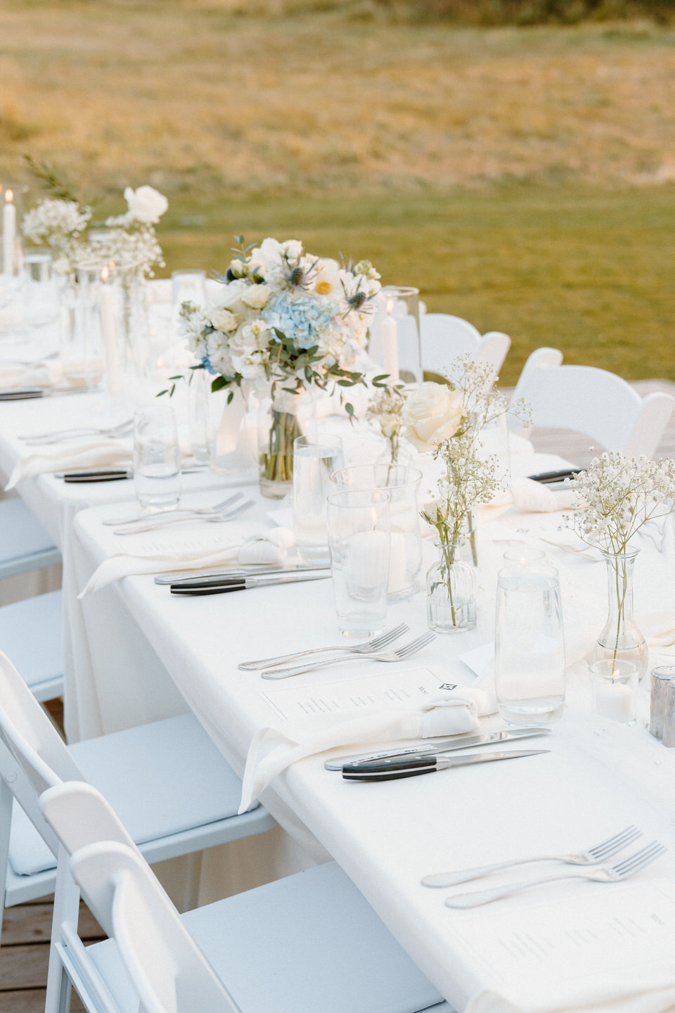 Chic white linens and decor on a table, creating an elegant scene in Black Butte, Oregon's scenic landscape.