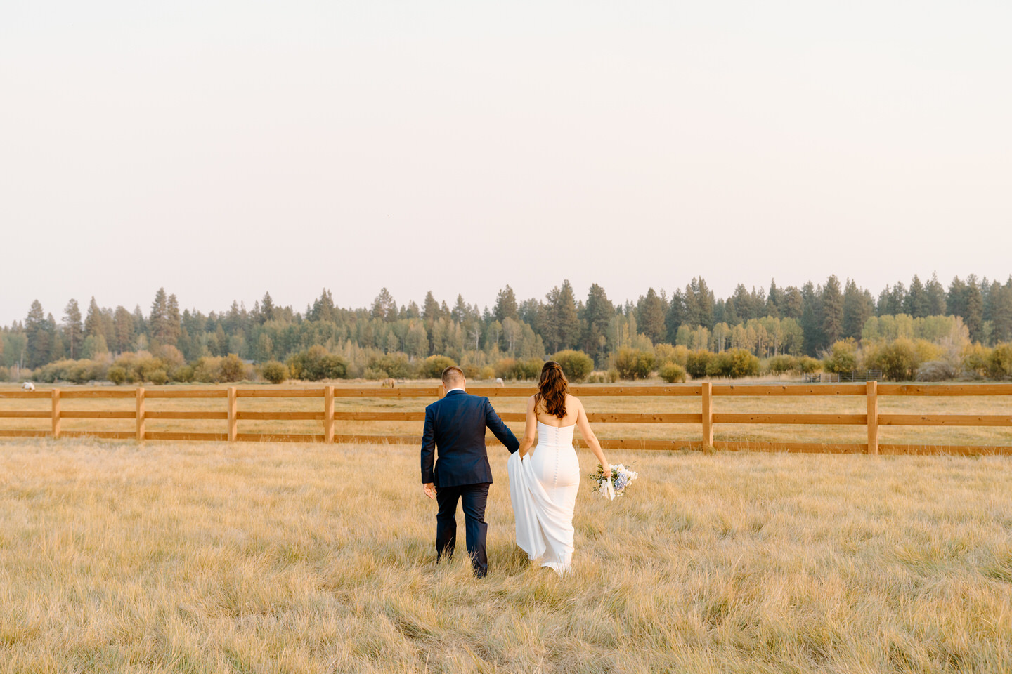 A romantic sunset at a Black Butte Ranch wedding highlights the bride and groom, framed by Central Oregon’s stunning landscape.