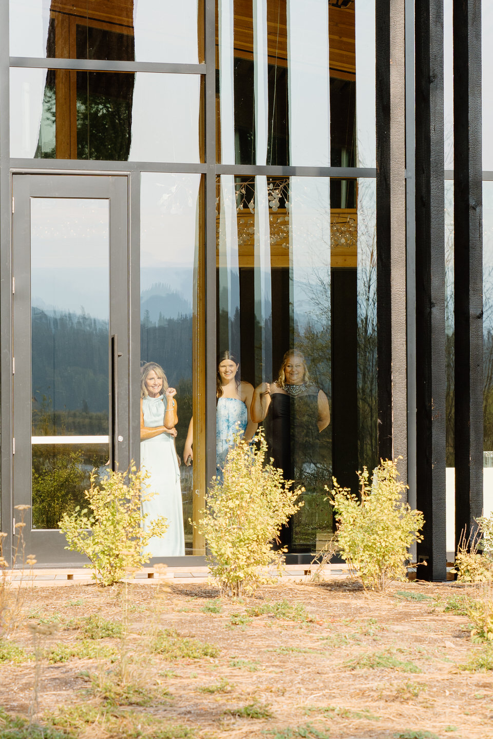 Family and friends watch as the bride and groom's first look takes place on the Black Butte Ranch lodge lawn.