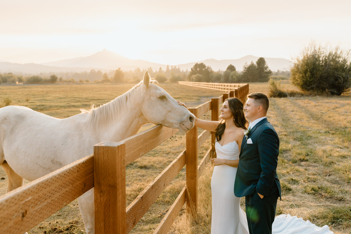 Bride and groom share a tender moment at sunset at their Black Butte Ranch wedding, surrounded by Central Oregon’s serene beauty.