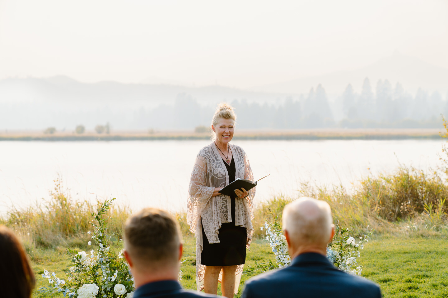 Officiant welcomes guests at Black Butte Ranch wedding ceremony in October.