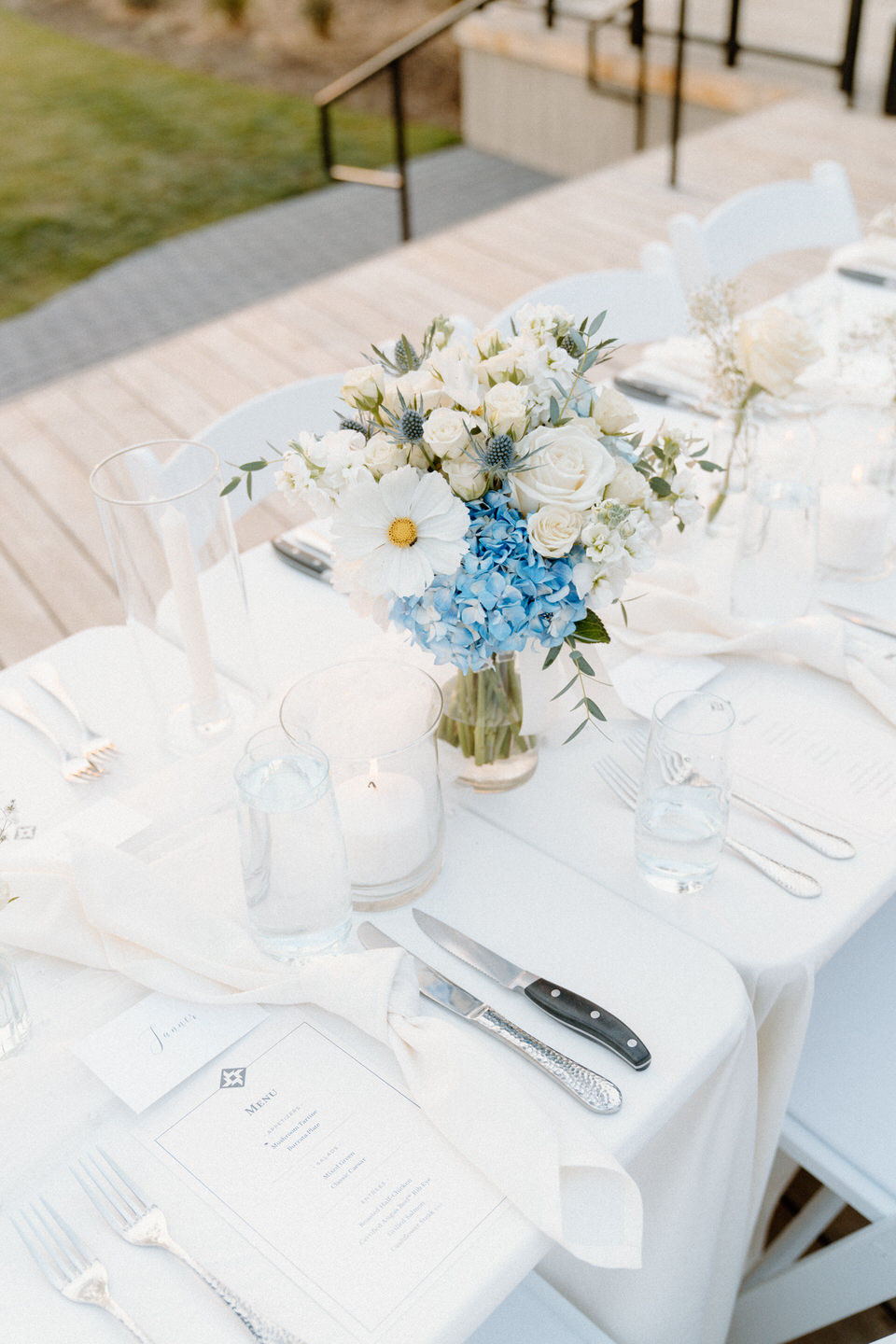 Long table with crisp white plates and simple glassware, styled for timeless elegance in Black Butte, Oregon.