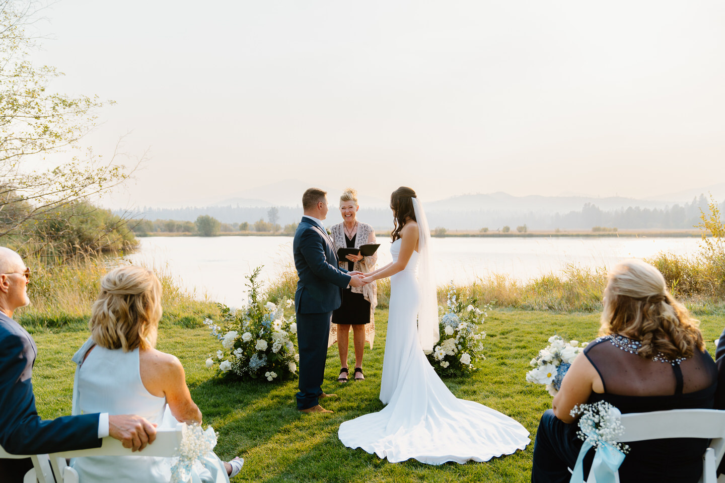 Holding hands during their vows, the bride and groom share an emotional moment at their Black Butte Ranch ceremony.