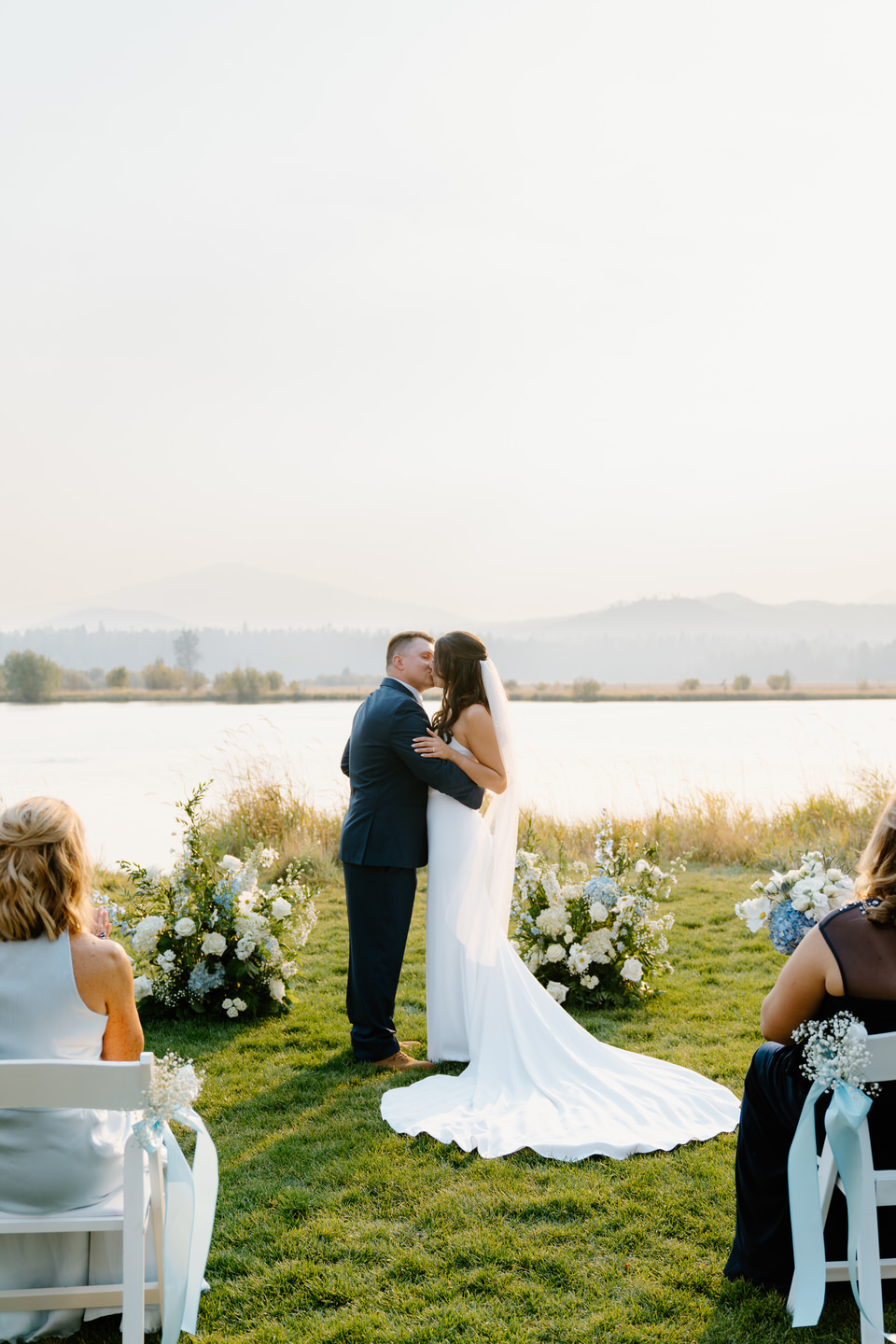 The bride and groom share their first kiss as a married couple during their ceremony at Black Butte Ranch.