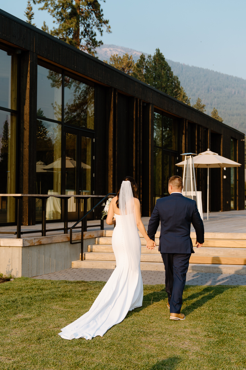 Bride and groom exiting their wedding ceremony towards the lodge at Black Butte Ranch.