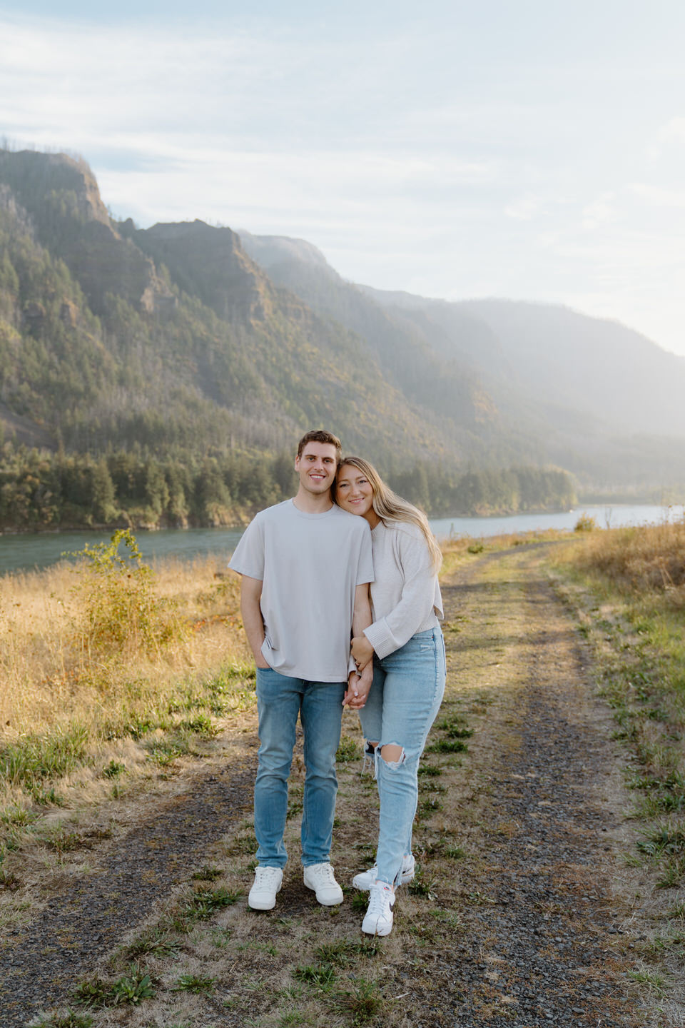 Couple smiling warmly at the camera for their Oregon engagement photos.