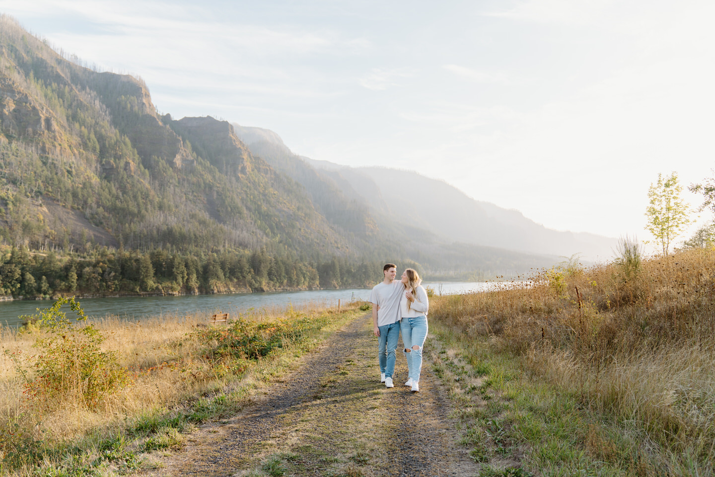 She holds his face while his arm wraps around her shoulder, sharing a intimate moment for their Oregon engagement photos.