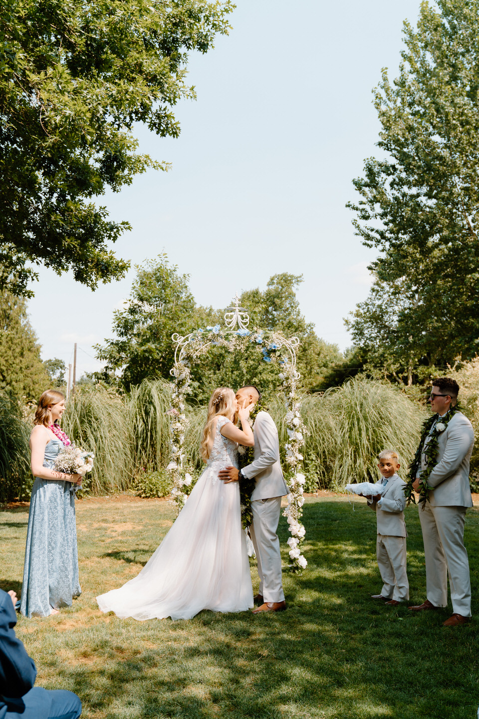 Bride and groom share their first kiss during a romantic Oregon wedding ceremony at Green Villa Barn.