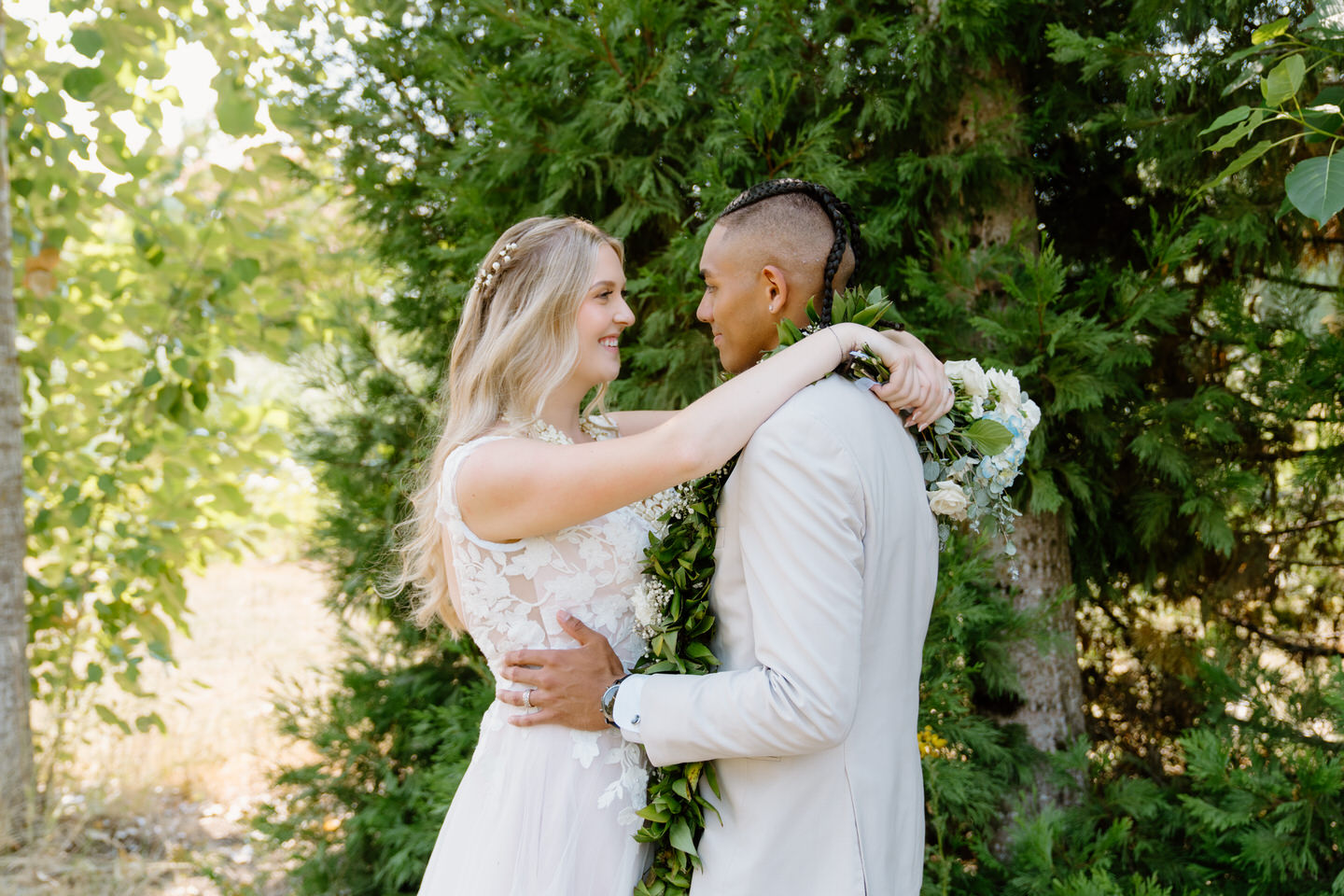 Bride and groom smile lovingly at each other during their wedding portraits at Green Villa Barn in Oregon.