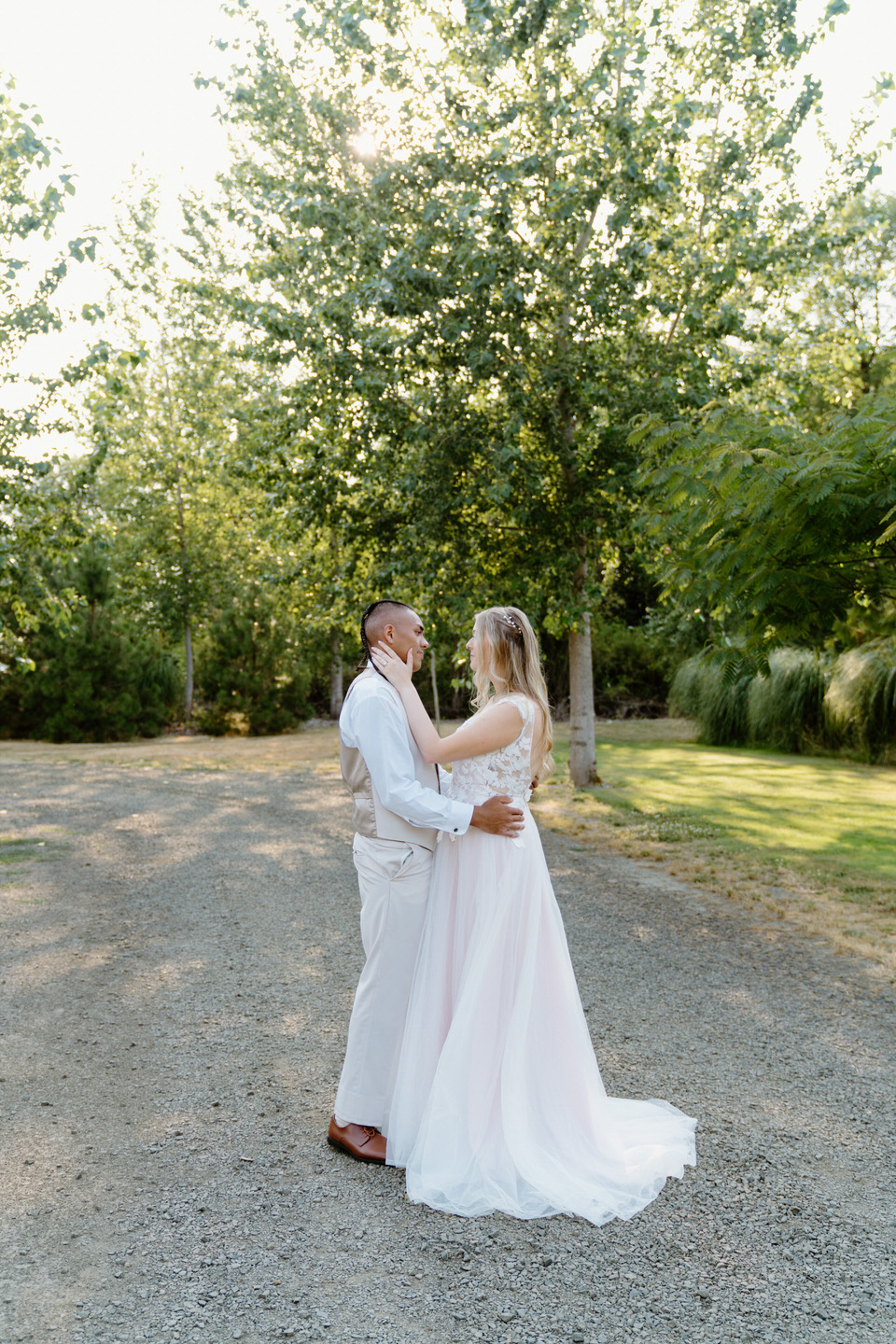 Bride and groom embrace as they take a moment to themselves during golden hour portraits.