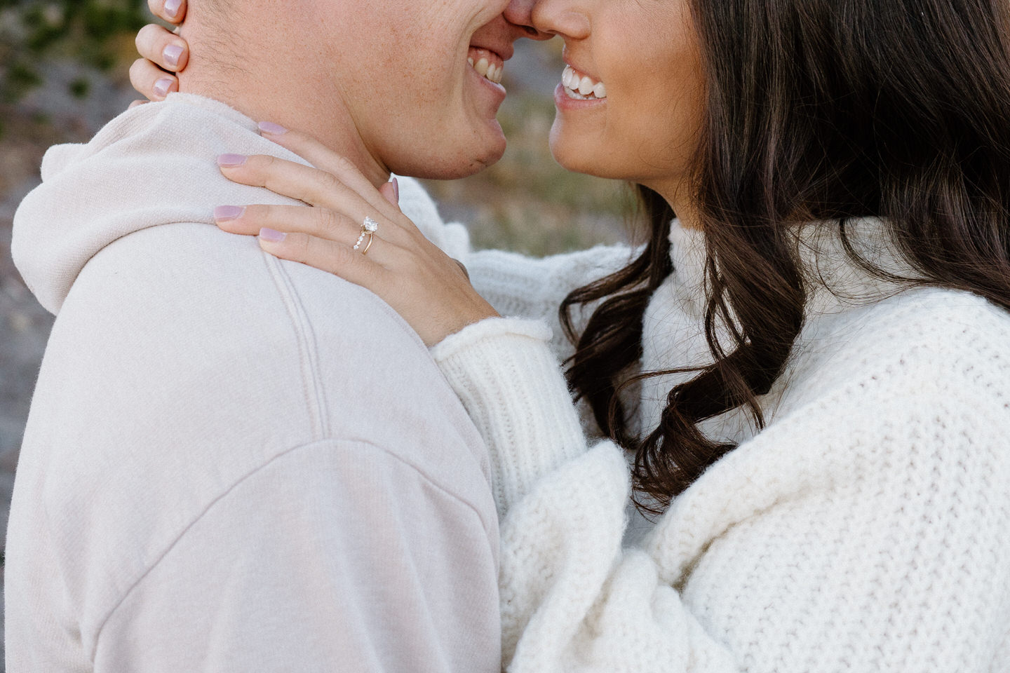 A couple laughing together in cozy casual outfits, surrounded by vibrant fall foliage during their Mount Hood engagement photos.