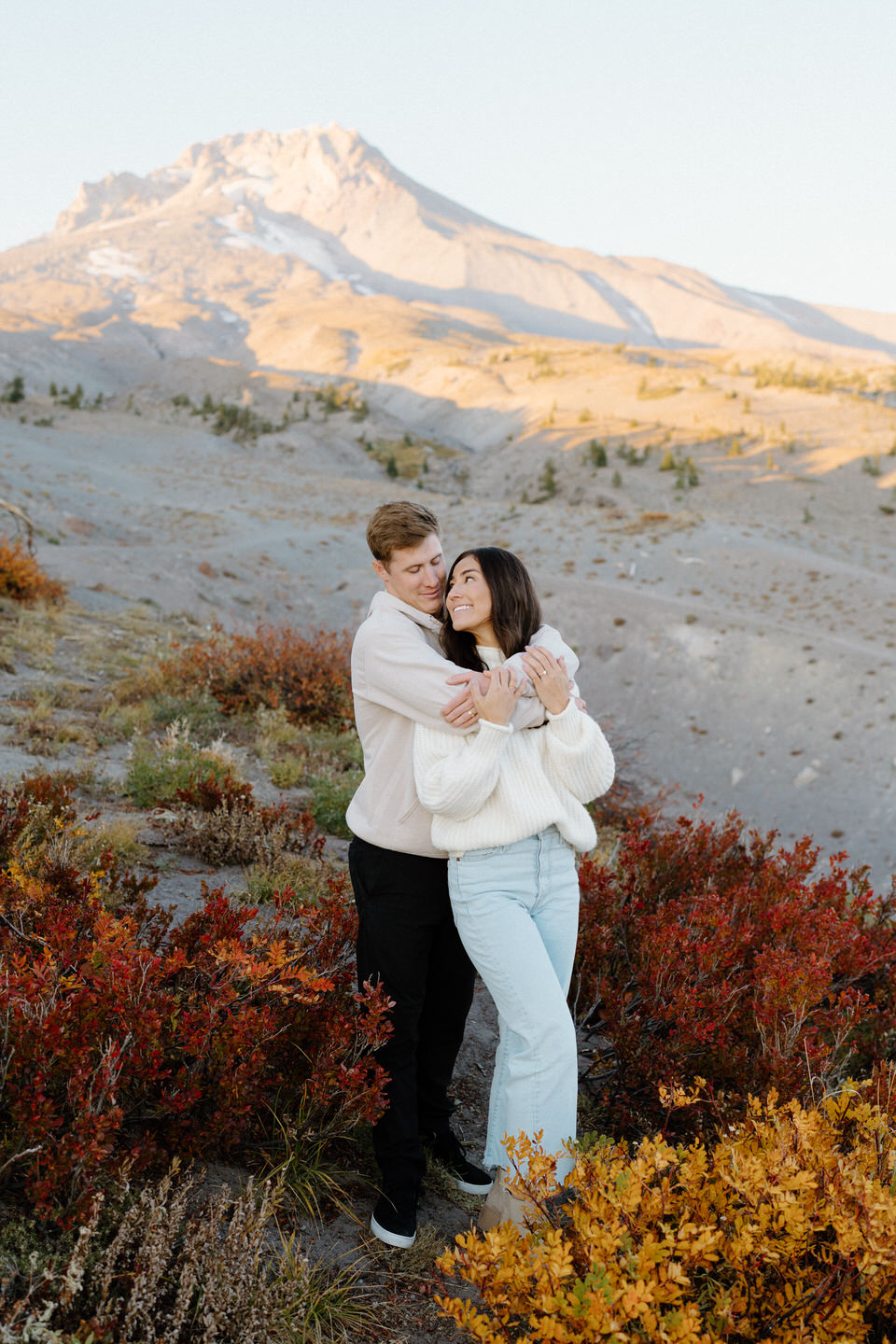 The couple gazing lovingly at each other while taking their Mount Hood engagement photos in the fall at Timberline Lodge.