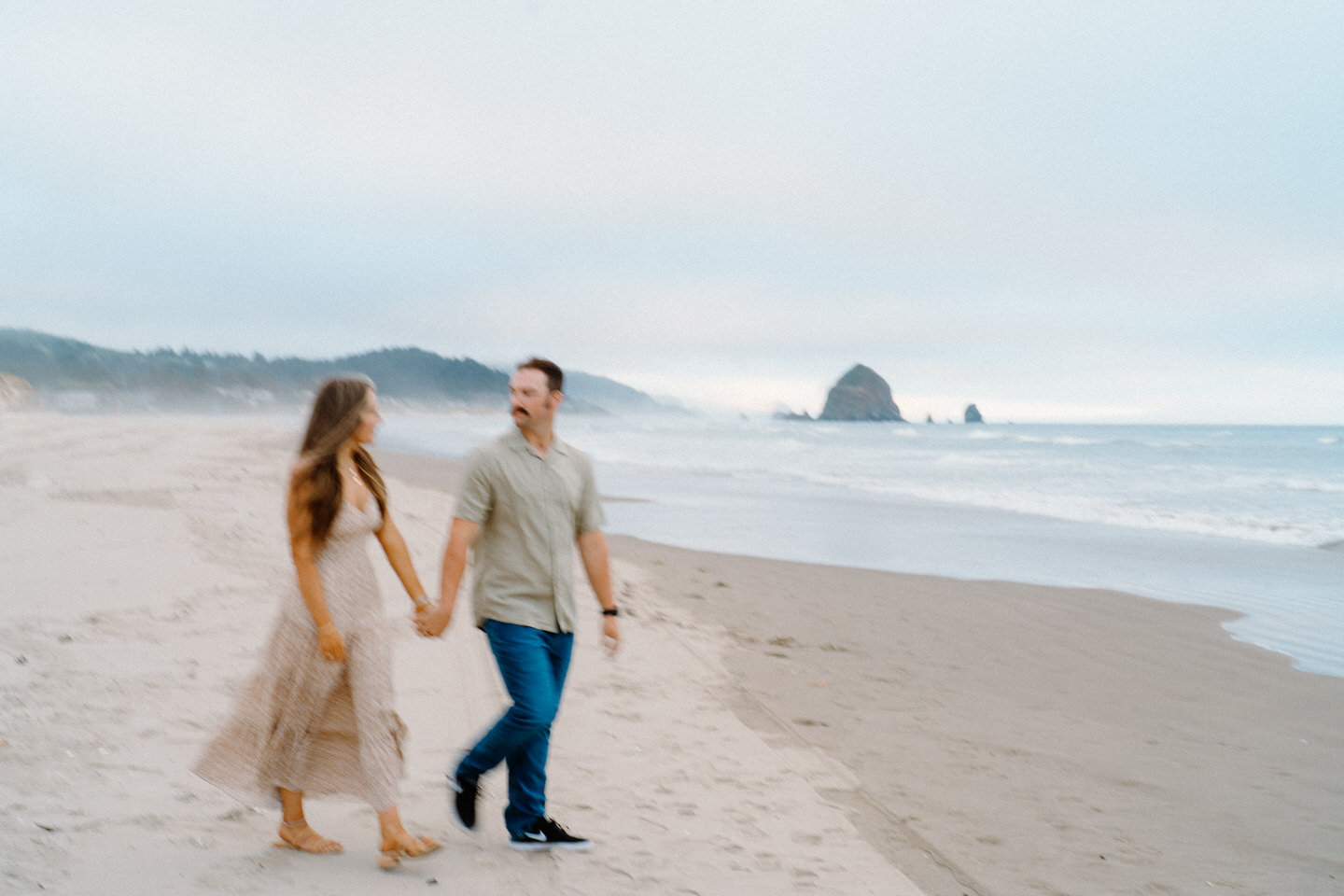 Dreamy blue hour engagement photos on the Oregon Coast with motion blur