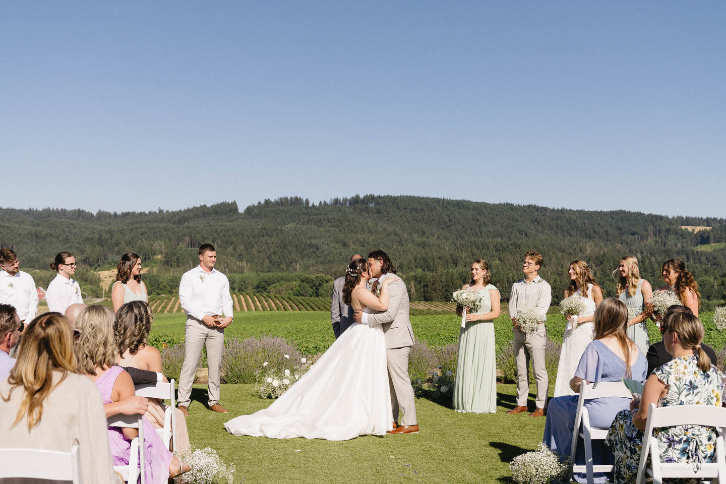 Bride and groom share their first kiss during Abbey Road Farm wedding in July.