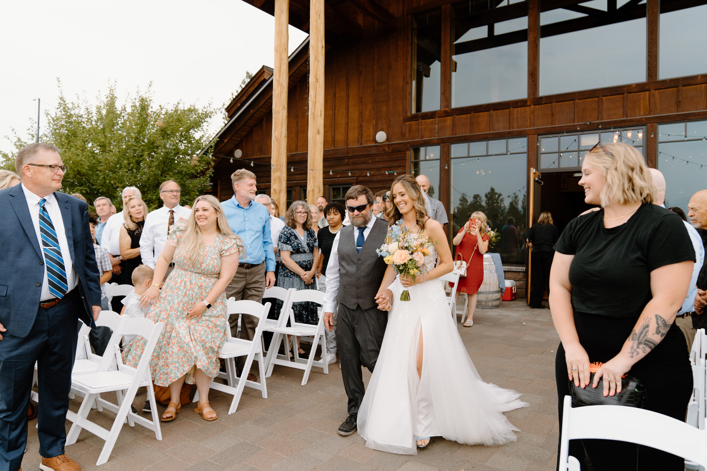 Bride and her father walking down the aisle to the ceremony at Aspen Lakes Golf Course wedding.